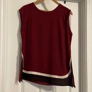 Limited maroon sleeveless blouse. Black and cream detail on bottom. size M